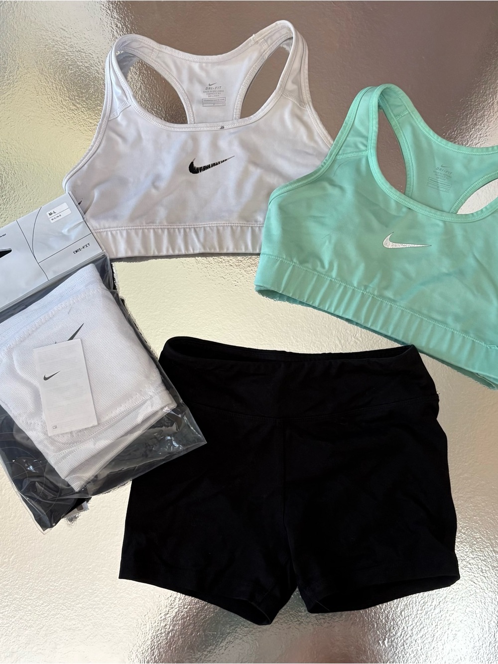 Ultimate volleyball pack: two Nike sports bras, DSG spandex, brand new knee pads